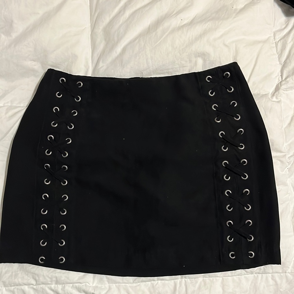 Black mini skirt with zipper; lace-up designs on sides